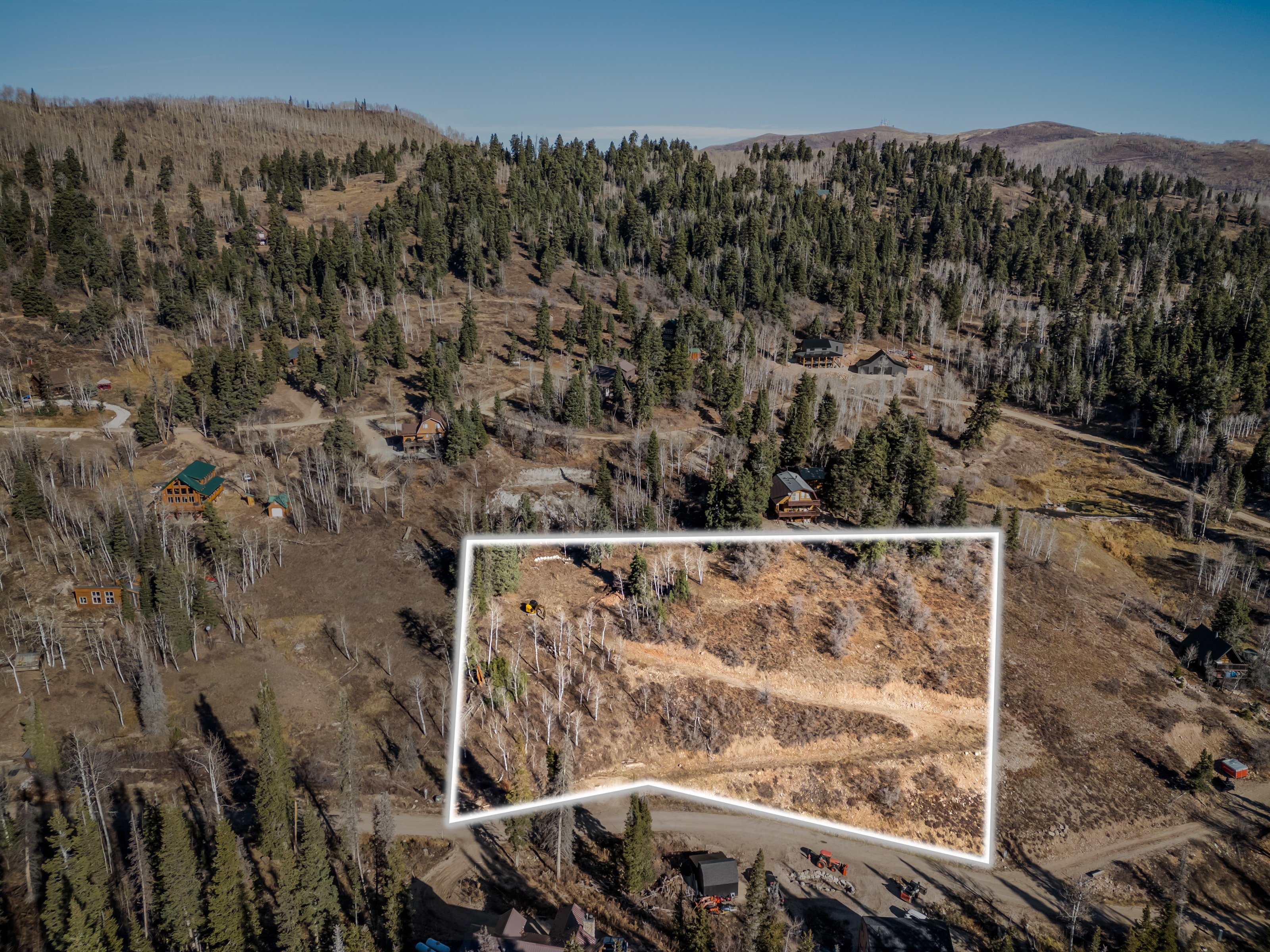 Aerial view of property's location with property parcel outlined and rural landscape