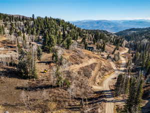 View of property location featuring a mountain backdrop and a forest