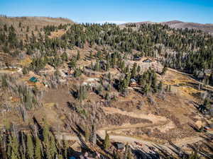 View of property location featuring a forest and a mountain backdrop