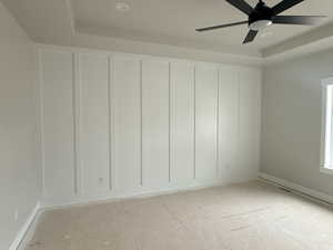 Unfurnished room featuring a tray ceiling, recessed lighting, and a ceiling fan