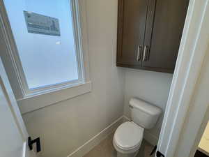 Bathroom featuring baseboards and tile patterned flooring
