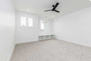 Empty room featuring light carpet, recessed lighting, and a ceiling fan
