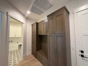 Mudroom with recessed lighting and light wood-type flooring