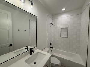 Full bathroom featuring vanity, shower / washtub combination, and recessed lighting