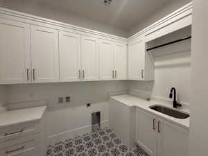 Laundry room with washer hookup, electric dryer hookup, and cabinet space