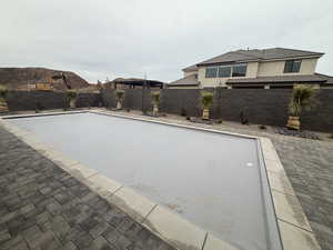 View of swimming pool with a fenced backyard and a patio area