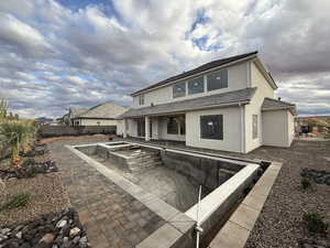 Back of house with a patio, stucco siding, a fenced backyard, and a tiled roof