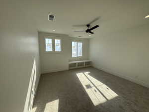 Spare room with carpet flooring, a ceiling fan, and recessed lighting