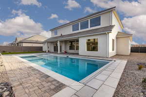 Back of house with a fenced backyard, a patio, stucco siding, and a tiled roof