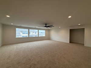 Unfurnished room featuring light colored carpet, recessed lighting, and ceiling fan