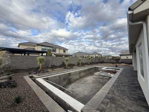 View of pool with a fenced backyard, a patio, and a residential view