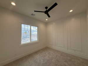 Carpeted empty room with recessed lighting and ceiling fan