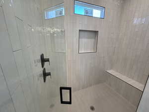 Bathroom featuring a tile shower