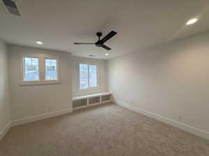Spare room with light carpet, recessed lighting, and ceiling fan