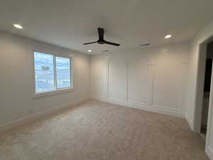 Empty room featuring light colored carpet, recessed lighting, and a ceiling fan