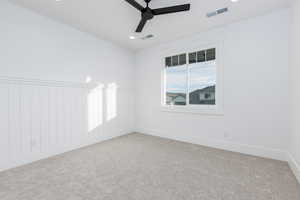 Spare room featuring ceiling fan, carpet flooring, and recessed lighting