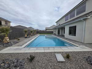 View of pool with a patio area and a fenced backyard