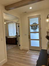 Foyer entrance with light wood-type flooring, recessed lighting, and beamed ceiling