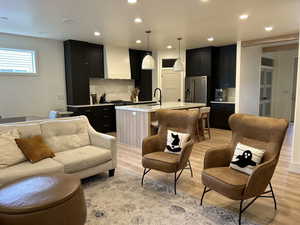 Living room featuring light wood-style flooring and recessed lighting