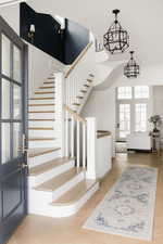 Entrance foyer featuring stairway and light wood-style floors