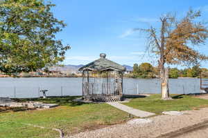 Dock featuring a yard and a water and mountain view