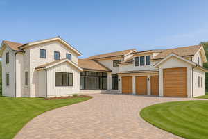 Modern farmhouse with decorative driveway, a front yard, a shingled roof, and stone siding
