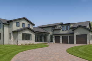 View of front of property with stone siding, a sunroom, and a shingled roof