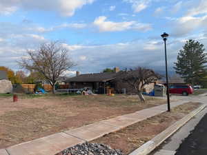 View of front of property with a trampoline and a chimney
