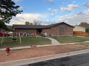 Ranch-style home featuring brick siding and a chimney