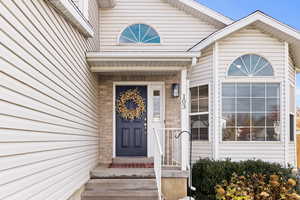 Property entrance featuring brick siding