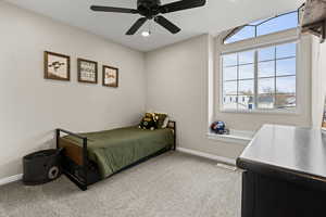 Bedroom featuring light colored carpet, ceiling fan, and recessed lighting