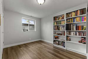 Spare room with light wood-type flooring and a textured ceiling