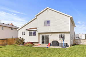 Back of property with a fenced backyard and a patio