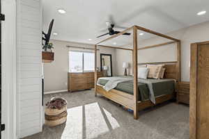 Bedroom with carpet, ceiling fan, recessed lighting, and a textured ceiling