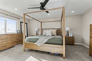 Carpeted bedroom featuring ceiling fan and recessed lighting