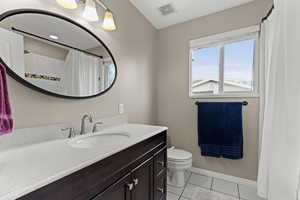 Bathroom with vanity, light tile patterned flooring, and a shower with curtain