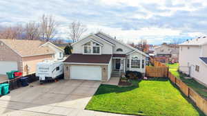 View of front of house with concrete driveway, an attached garage, brick siding, roof with shingles, and a residential view