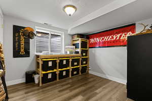 Bedroom featuring a textured ceiling and wood finished floors