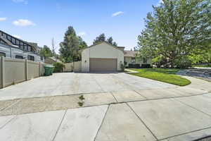 View of front facade with concrete driveway and a garage