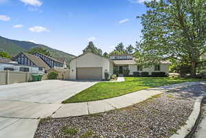 View of front of house featuring driveway, an attached garage, and a mountain view