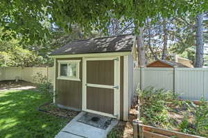 View of shed featuring a fenced backyard
