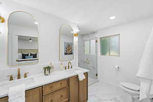 Full bath featuring double vanity, a marble finish shower, light marble finish flooring, recessed lighting, and ceiling fan