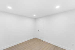 Unfurnished room featuring light wood-style floors and recessed lighting