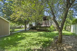 Rear view of house featuring a deck and stairs