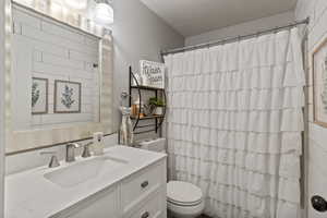 Bathroom featuring vanity and a textured ceiling