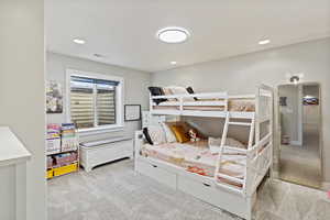Carpeted bedroom with recessed lighting