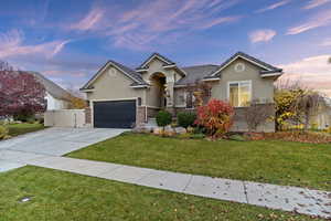 Ranch-style house featuring stucco siding, concrete driveway, an attached garage, brick siding, and a tiled roof