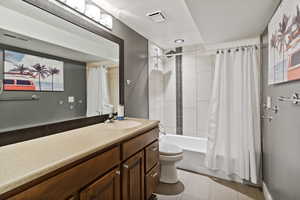 Bathroom featuring shower / tub combo with curtain and vanity