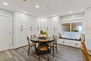 Dining space featuring light wood finished floors and recessed lighting