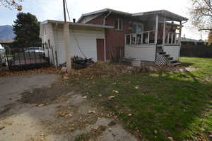 Rear view of property featuring brick siding and a mountain view